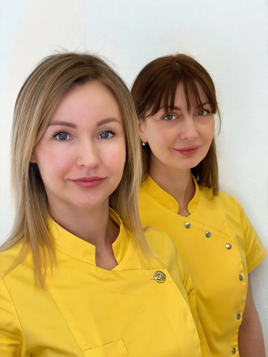 Dvi PINKOVA specialistės geltonomis uniformomis